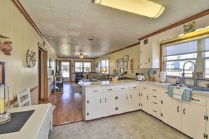 Enjoy cooking in this well-equipped kitchen with a central island, ample counter space, and cabinets for storage.