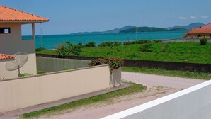 A coastal property with a view of the sea, a satellite dish, and a flower pot.