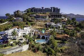 A coastal resort with multiple buildings, a swimming pool, and lush greenery. - Dreamy Spanish-Style Villa with Sweeping Ocean Views, Elegant Nautical Design & (Flamingo)