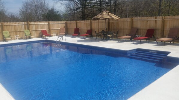 A rectangular swimming pool with a wooden deck and lounge chairs. - Abigail's Country House. 2 minutes To Skiing. Swimming, Hiking very close by. (Hunter)