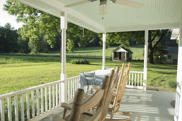 The back porch looks out to the garden and pastures