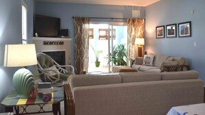 A living room with a sofa set, a television, a lamp, and a chair. - Spacious and Well Appointed Three Bedroom, Two Bath Condo situated just outside the Town of Lewes Delaware (Lewes)