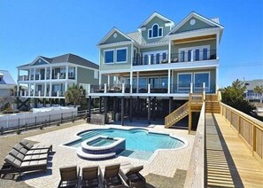 Enjoy a beachfront retreat with a multi-level pool and covered deck area.