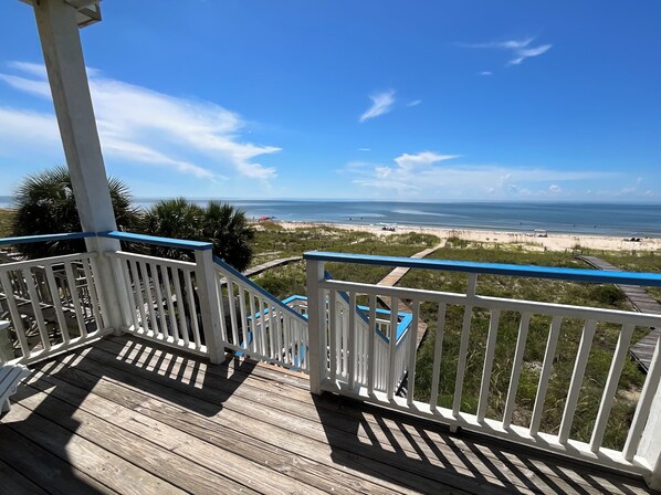 A wooden deck with white railings overlooking a beach and ocean. - Beachfront Single House! 3B3B+6 Person Hot Tub -Gorgeous Views w/Fun Decoration (St George Island)