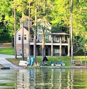 A large house with a dock extending into a body of water.