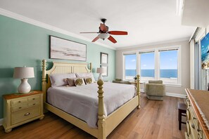 A bedroom with a bed, nightstands, a chair, and a view of the ocean. - 🏖️  Oceanfront Boardwalk unit w/ Pool Just Renovated steps to Downtown Events 🏖️ (Ocean City)