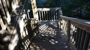 A wooden staircase leading to a bridge over a calm lake surrounded by trees. - MTN CABIN LAKEFRONT,CANOE/3 KAYAKS,POOL TABLE,DOCK,FIRE PIT, FIREPLACE,JACUZZI (Butler)