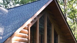 A log cabin with a wooden door, a window, and a sign that reads "WATERS EDGE." - MTN CABIN LAKEFRONT,CANOE/3 KAYAKS,POOL TABLE,DOCK,FIRE PIT, FIREPLACE,JACUZZI (Butler)