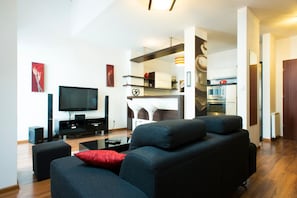 Relax in this stylish living space with a large sofa, modern armchair, and comfortable seating area.