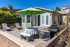 Relax in the patio area with a barbecue grill, lounge chairs, and a table.