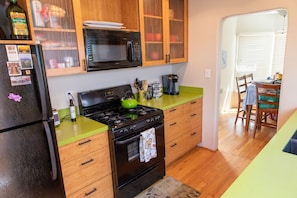 Enjoy cooking and dining in this well-equipped kitchen with a stove, microwave, and coffee maker.