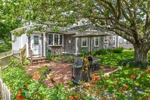 A house with a covered patio, a grill, and a fenced yard. - On the Chatham Loop - 1 Min to the Beach! (Chatham)