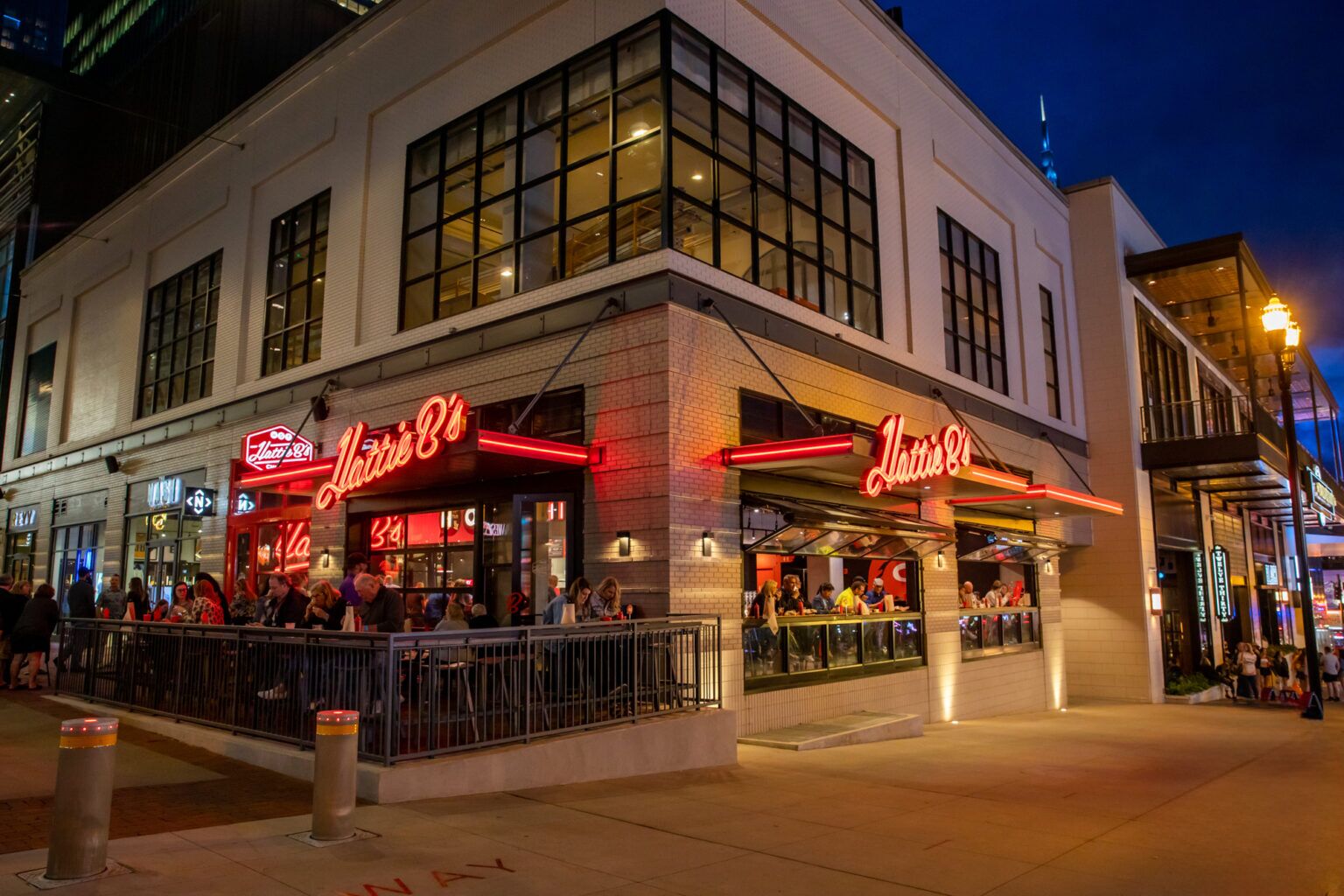 A building with two visible storefronts, each with a neon sign reading "Lattie's."