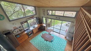 A spacious kitchen with large windows, a dining area, and a view of the outdoors.