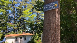 Une enseigne indiquant « Wee White Cottage », situé au 125, chemin Fernald.