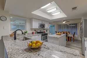 Updated kitchen looks flashy with new cabinets and counter tops.