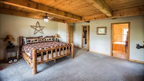 Ein rustikales Schlafzimmer mit einem hölzernen Bett, einer Sterndekoration und einem Schrank mit Spiegel.