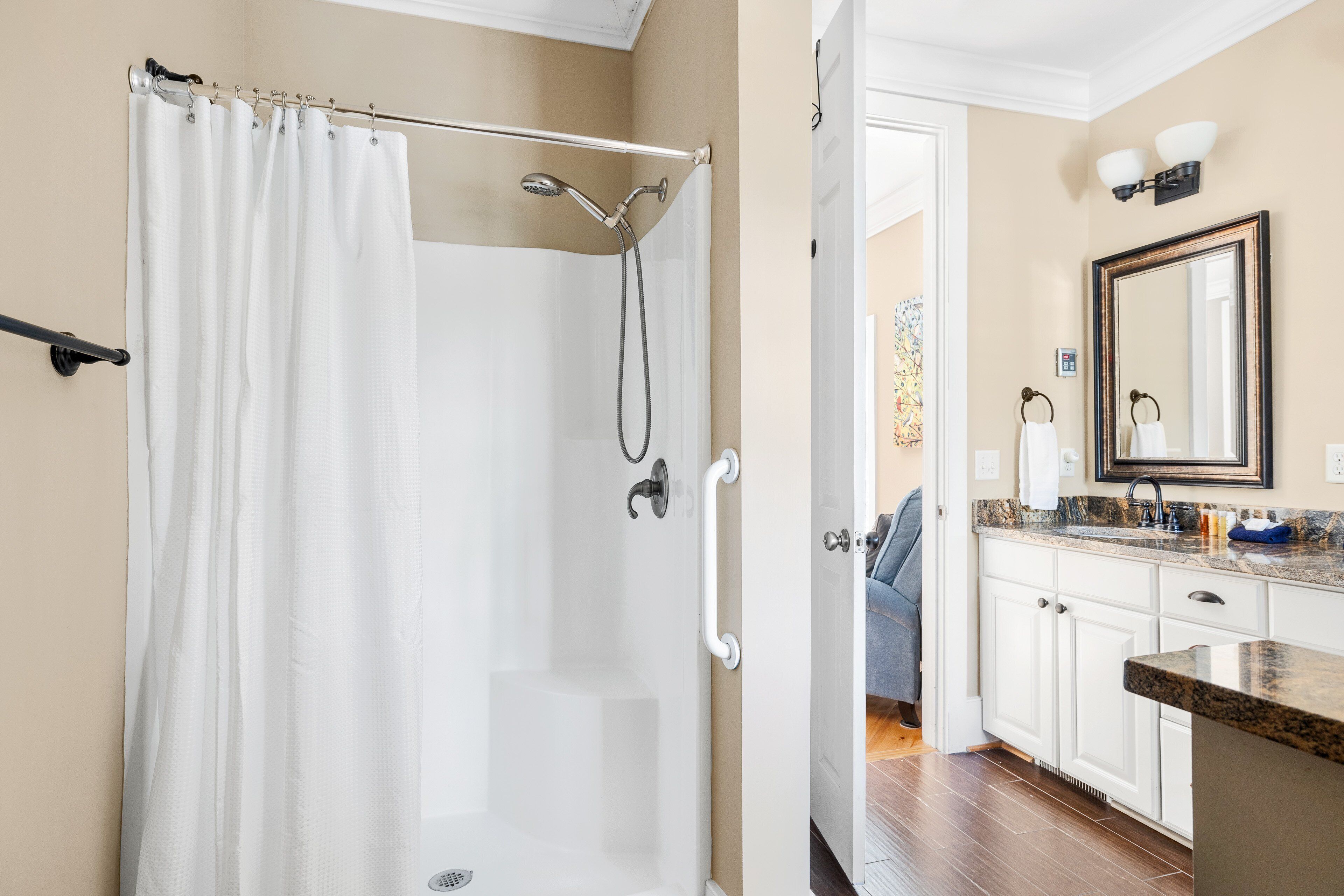 A bathroom with a shower, toilet, and sink.