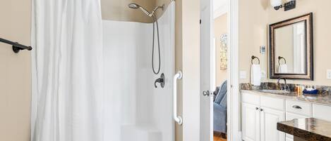 A bathroom with a shower, toilet, and sink.