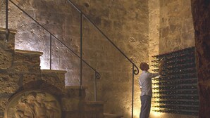 A stone staircase with a metal railing leading to a wine cellar. - A unique luxury home, designer interiors, in a fairytale town (Civita di Bagnoregio)