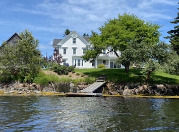 View of the house, backyard and private dock taken from the water