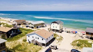 A coastal residential area with houses, a beach, and a clear view of the ocean. - OCS4 Semi-Ocean-Front Home with Gorgeous Views (Nags Head)