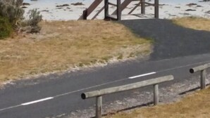 A beach with a wooden staircase leading down to the shore, a paved path, and a road adjacent to the beach. - Gillian's on the beachfront Port MacDonnell, the best view in town. (Port MacDonnell)