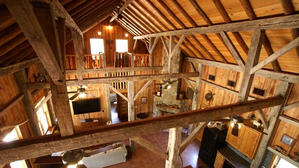 A rustic wooden cabin with a loft bedroom, a kitchen, and a dining area. - Lake Buchanan Lodge featuring optional Pavilion with free kayaks and canoes. (Buchanan Dam)