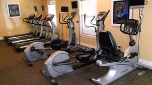 A gym with treadmills, stationary bikes, and elliptical machines. - Spacious one bedroom-one bath condo (Naples)