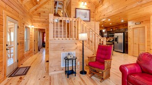 A wooden cabin interior with a staircase, a dining area, and a kitchen. - CREEKSIDE LOG HOME: NEXT TO CREEK / CLOSE TO TOWN / HOT TUB / TRAILS / PETS OK (Black Mountain)