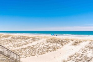 A beach with a sandy foreground and a clear blue sky. - Feels Like Home-3 BR Oceanfront Duplex; Covered Porches (Topsail Beach)
