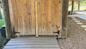 A wooden gate with metal hinges and a wooden deck leading to it. - Oceanfront Home on Folly Beach, SC (Folly Beach)