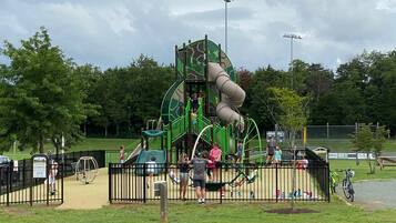 Children can play on the climbing structure with multiple slides and platforms.