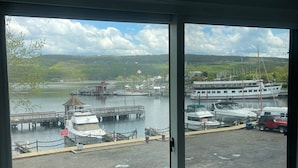 Ein Yachthafen mit vertäuten Booten, einer Anlegestelle und einer Aussicht auf Hügel in der Ferne.