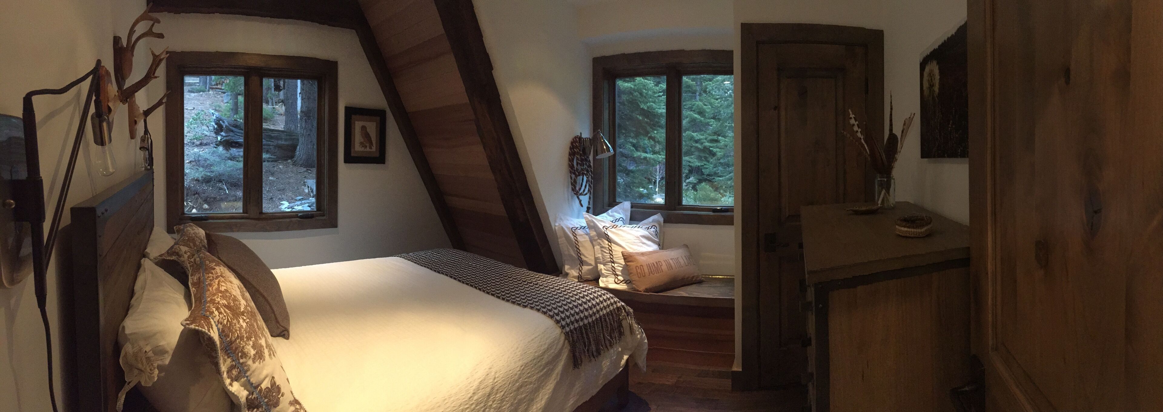 Second floor guest room with a queen bed, half bath in hall outside room. 