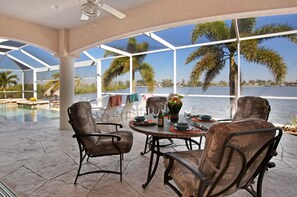 Outdoor dining - Villa Laguna - Stunning Views! Elec & solar heated pool, spa on Gulf-access canal - SWFL Rentals (Cape Coral)