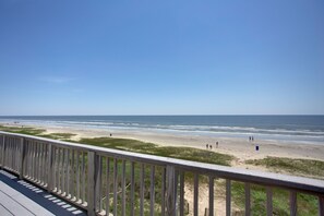 A beach view from a wooden deck with a railing. - 4 Bdr., 2.5 Bath Beachfront Home. Recently painted and a fresh kitchen remodel. (Galveston)