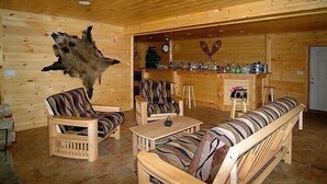 A wooden interior with a bar area, wooden furniture, and a mounted animal head. - Mountain retreat near Hunter/Windham Mountain (Prattsville)