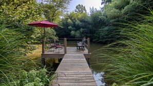 A wooden dock extending into a calm body of water, surrounded by lush greenery. - Beautiful Waterside Cabin (2), Great Location, View, 8 Min To Downtown, Biltmore (Asheville)