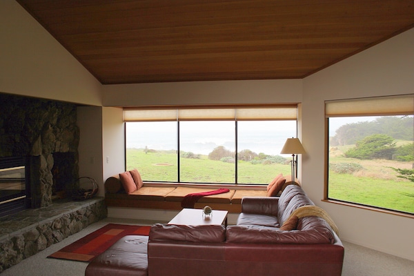 Family Room with view to bluff and ocean. We supply the wood for the fireplace