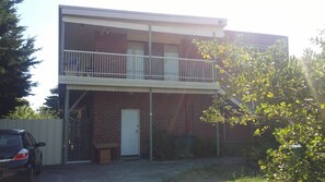 A two-story building with a balcony on the upper floor.