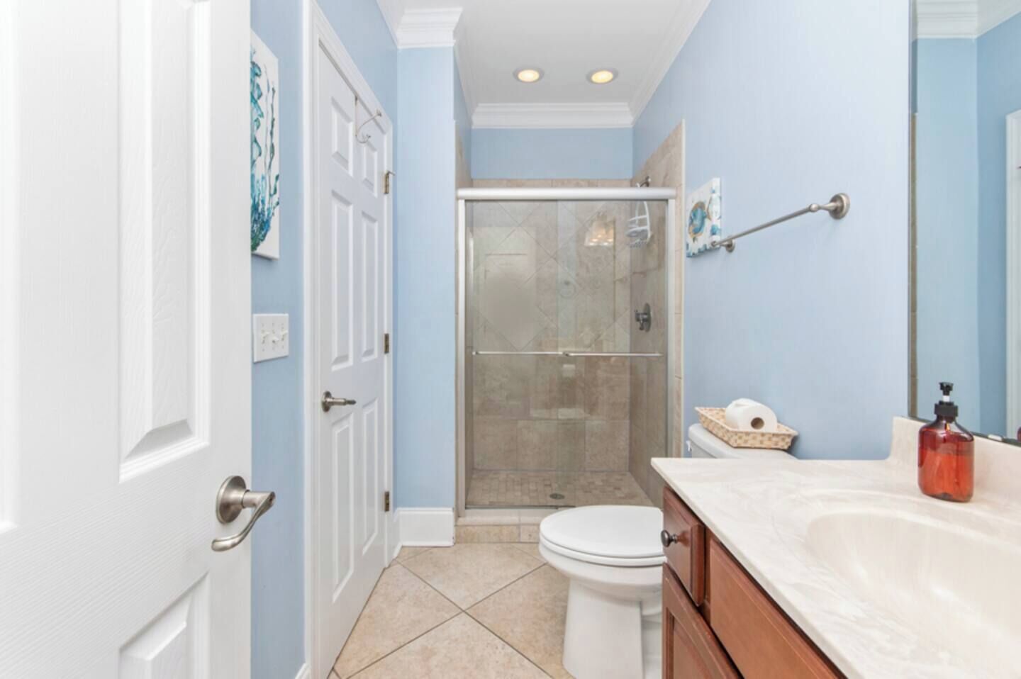 A bathroom with a shower, toilet, and vanity.