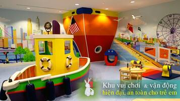Explore a vibrant play area designed for kids, featuring a large ship model and play structures like a Ferris wheel and carousel.