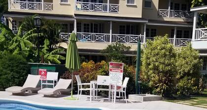 Modern Barbados condo with WIFI, walk out to POOL, steps from BEACH