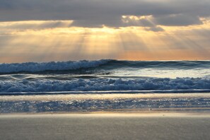 A beach with waves and sunlight.