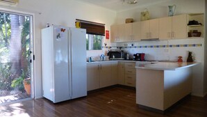 A kitchen with a refrigerator, stove, microwave, and cabinets.