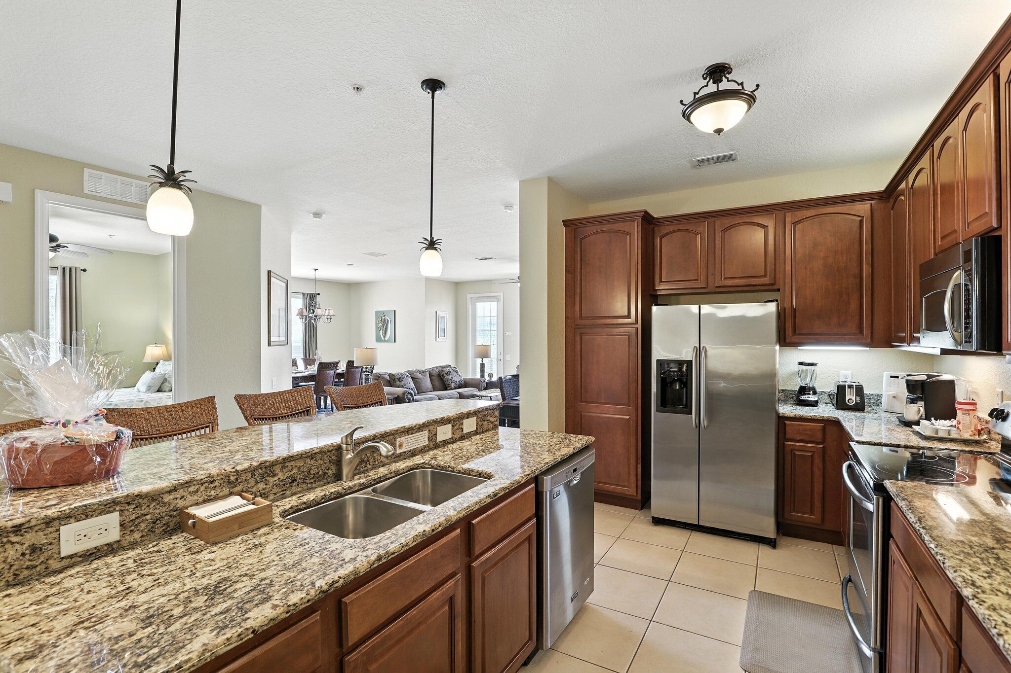 A modern kitchen with granite countertops, stainless steel appliances, and wooden cabinets.