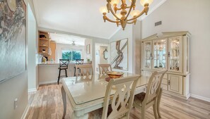 Gather around your elegant dining table beneath a statement chandelier, with the bright kitchen just steps away for easy entertaining. - Sprinkle of Irish charm, beautifully updated, Siesta Dunes 8-205 (Siesta Key)