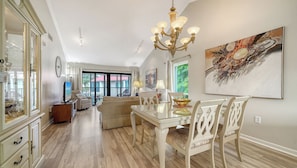 A bright, open-concept living and dining area welcomes you with vaulted ceilings, elegant lighting, and views to your private balcony. The space flows seamlessly from conversation to meals, creating your ideal gathering spot. - Sprinkle of Irish charm, beautifully updated, Siesta Dunes 8-205 (Siesta Key)