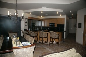 A view from the living room of the dining area and kitchen.